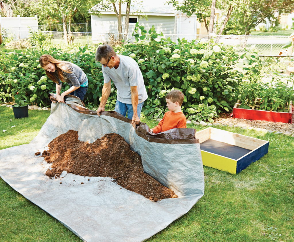 Family making Mel's Mix on a tarp