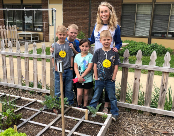 children planting sfg with teacher